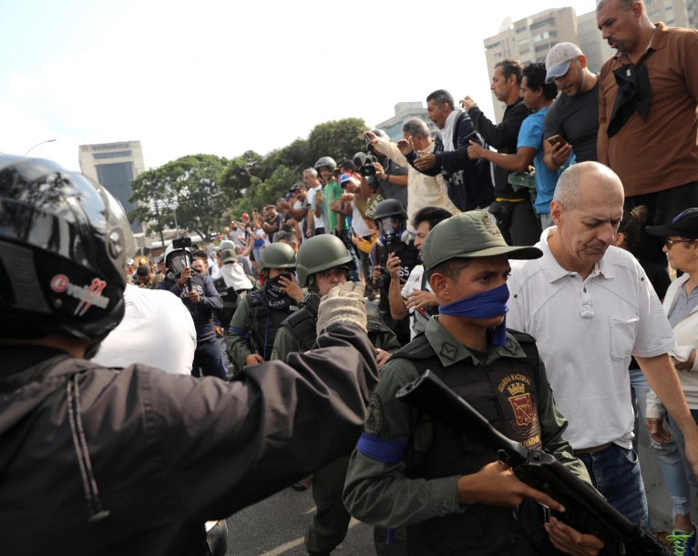 Venezuela's Guaido urges troops to rise, mass protests planned